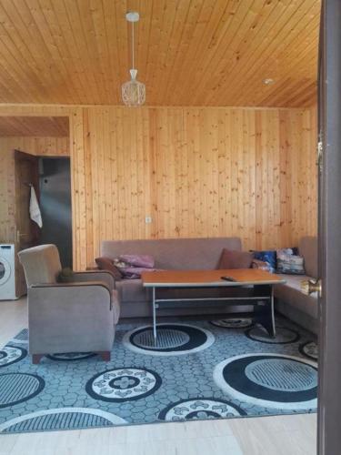 a living room with a couch and a table at family hostel in K'veda Bzubzu