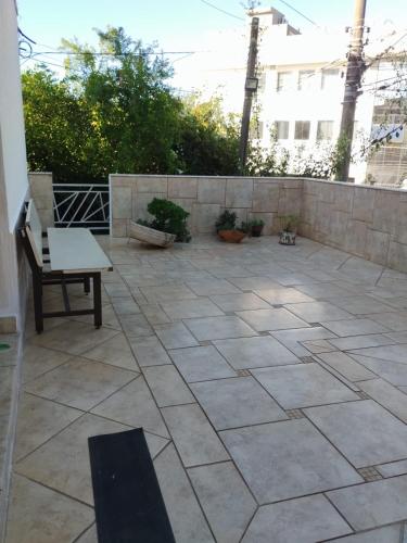 a patio with a bench and a stone wall at Casa Agapeama in Jundiaí