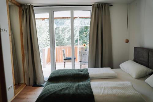 a bedroom with a bed and a sliding glass door at Ferienwohnung Goldtann in Elzach