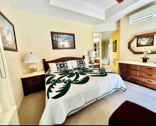 a bedroom with a large bed and a sink at The Palms Unit 501, condo in Wailea