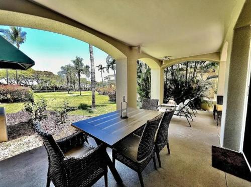 a dining area with a table and chairs on a patio at The Palms Unit 501, condo in Wailea