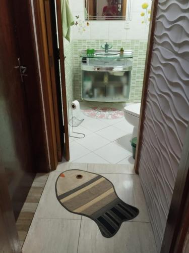 a bathroom with a sink and a toilet in a room at Casa Agapeama in Jundiaí