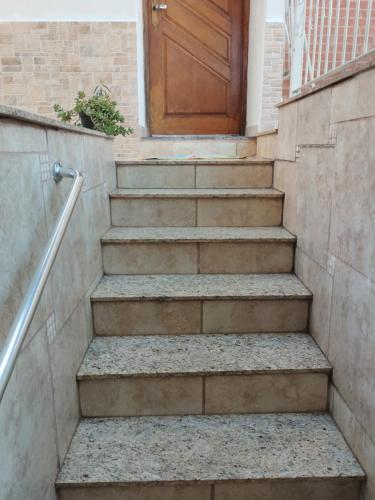 a set of stairs with a wooden door at Casa Agapeama in Jundiaí