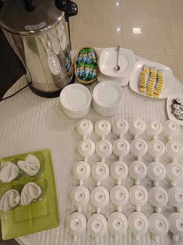 a table with a bunch of paper plates and a blender at New Al-Safina Hotel in Lahore