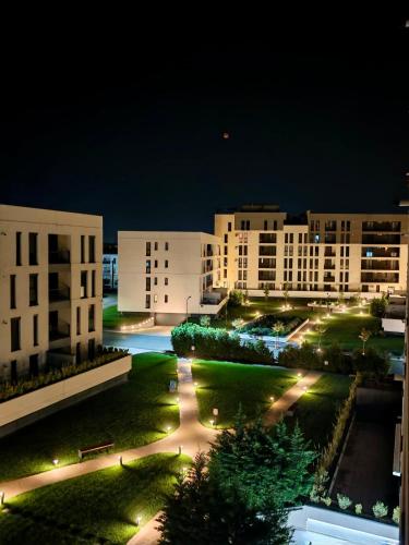 a view of a campus at night with buildings at Modern Apartment with Free Private Parking in Timisoara in Timişoara