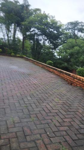 a brick road with trees in the background at Hamba Kancane Ma-Africa Guest House in Graskop