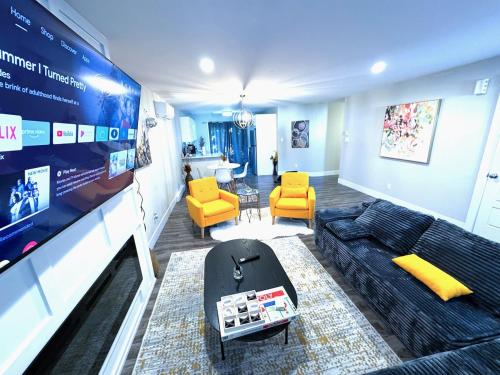 a living room with a couch and a tv at Private Home Near Moncton Hospital&Downtown in Moncton