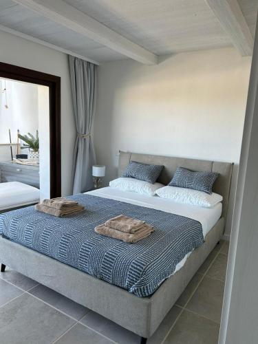 a bedroom with a bed with two towels on it at TheView108, Rena Bianca in Baja Sardinia