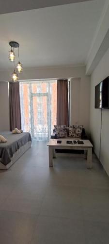 a large room with a bed and a table in it at New Alvina in Tsaghkadzor