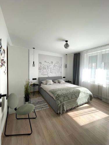 a white bedroom with a large bed and a window at sarajevo2go in Sarajevo
