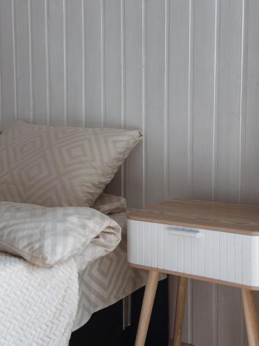 a bed with a night stand next to a bed with a side table at Go Карпати in Verkhovyna