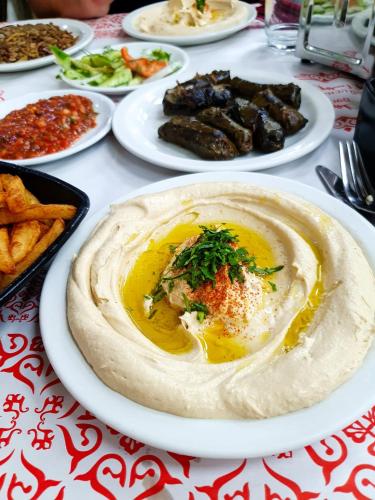 a table with plates of food on a table at DovrInn Boutique ApartHotel DownTown in Haifa