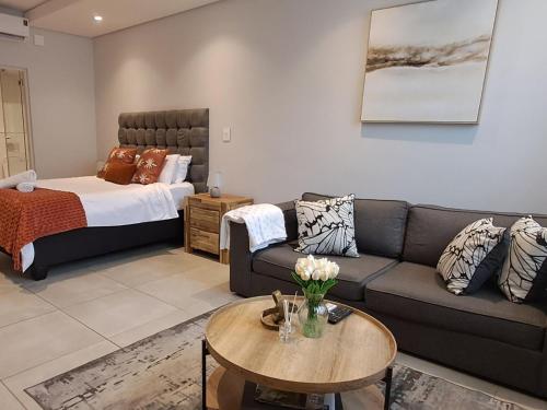 a living room with a couch and a bed at Zimbali Lakes Boulevard Suites 145 in Ballito