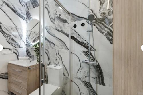 a bathroom with a shower with a toilet and a sink at Sun Garden in Adeje