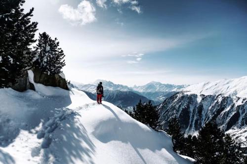 a person standing on top of a snow covered mountain at LOGE Alta Crystal in Enumclaw