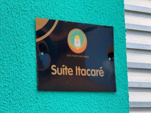 a book on a wall with a picture of a cat at Suíte Porto das Dunas in Salvador