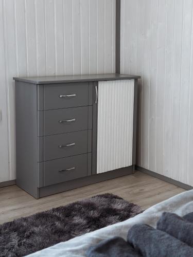 a dresser in the corner of a bedroom at Go Карпати in Verkhovyna