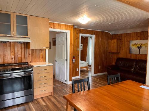 a kitchen and living room with a table and a couch at Camping Chalets Lac St-Augustin in Quebec City