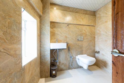 a bathroom with a toilet and a sink at Hotel Imperial inn in Mumbai