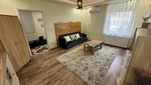 a living room with a couch and a table at Oliva Apartman in Salgótarján