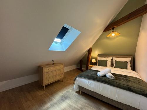 a bedroom with a bed and a skylight at Au Grand Cèdre - garden and billiard with family in Tacoignières
