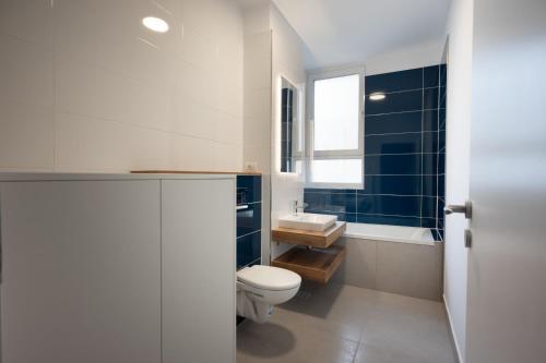 a bathroom with a toilet and a sink at Iulius Town Residence in Timişoara