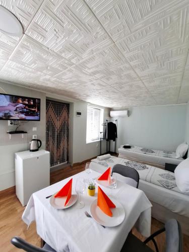 a living room with two tables and two beds at La vie in Opanets