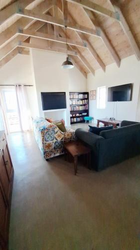 a living room with two couches and a table at Tweede Lente in St Helena Bay