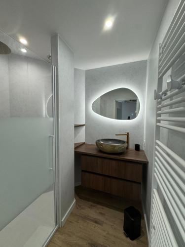 a bathroom with a sink and a mirror at Maison La tranche-sur-mer Vue mer in La Tranche-sur-Mer