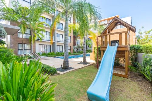 a slide in the yard of a apartment at Thematic beach apartment in CapCana area in Punta Cana