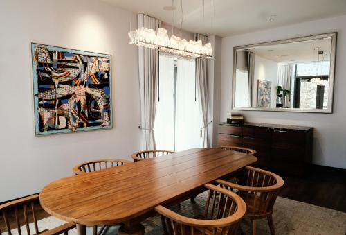 a dining room with a wooden table and chairs at Kimpton Hotel Eventi by IHG in New York