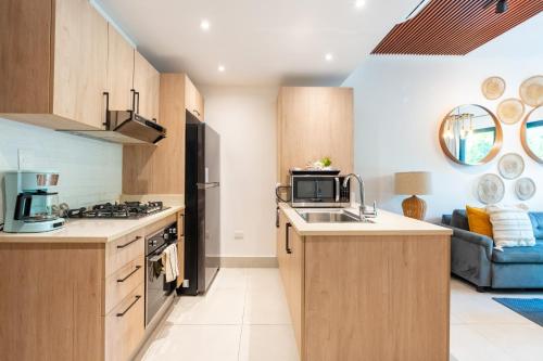 a kitchen with a sink and a stove top oven at Thematic beach apartment in CapCana area in Punta Cana