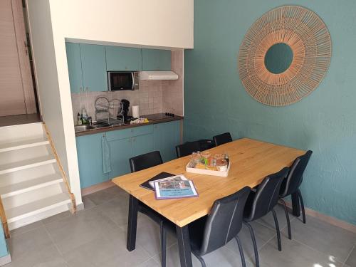 a dining room with a wooden table and chairs at Casa Cool - Climatisation réversible et Nature in Virton
