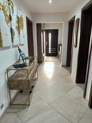 a hallway with a glass desk and a room at Dom Amélia in Snina