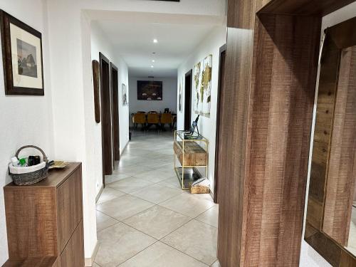 a hallway of a home with white walls and tile floors at Dom Amélia in Snina