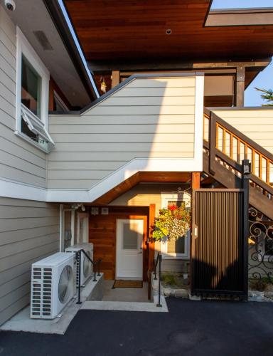 a house with a porch with a door and a window at Sidney Solace 1BR Suite Minutes from Waterfront in Sidney