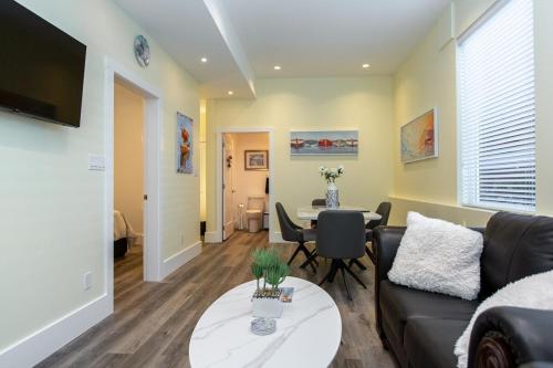 a living room with a couch and a table at Sidney Solace 1BR Suite Minutes from Waterfront in Sidney