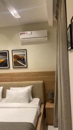 a hotel room with two beds and a air conditioner at Adar Hotel in Lagos