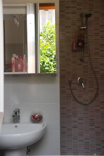 a bathroom with a sink and a shower with a mirror at Villino Amabile in Fiumicino