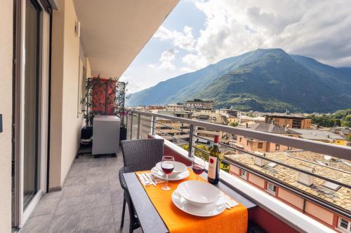 a balcony with a table and a view of a mountain at Quinta Stella in Tirano