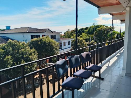 a row of chairs sitting on top of a balcony at Hotel Volga in Puerto López