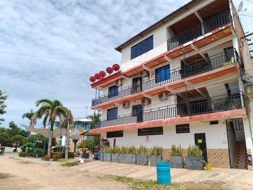 a building with balconies on the side of a street at Hotel Volga in Puerto López
