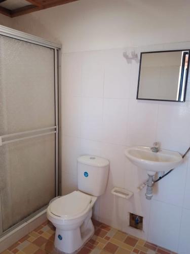 a bathroom with a toilet and a sink at Hotel Volga in Puerto López