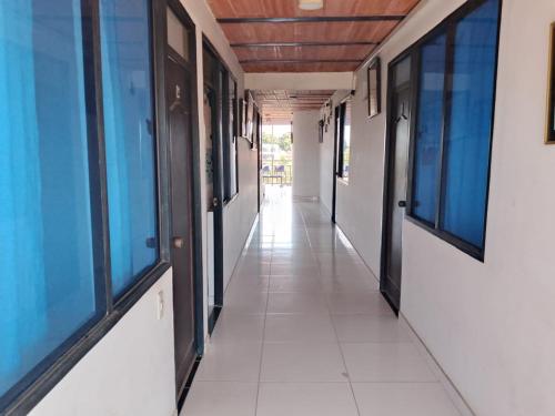 an empty corridor in a building with windows at Hotel Volga in Puerto López