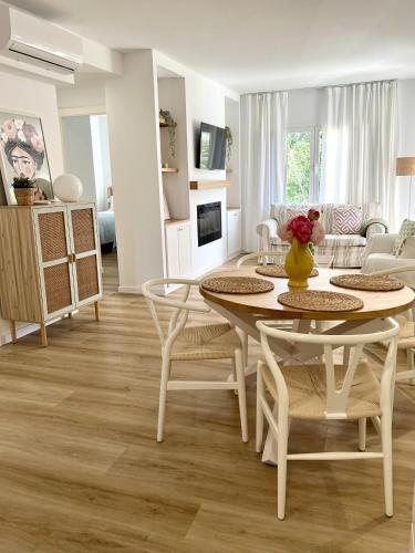 a white living room with a table and chairs at Elena Playa Sol in Alcudia