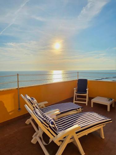 a balcony with two lounge chairs and a table at La Terrazza sul Mare in Montesilvano