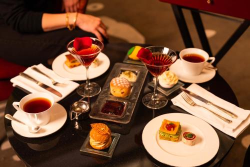 a table topped with plates and cups of tea and desserts at Raffles Istanbul in Istanbul