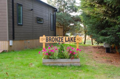 a sign that reads browse lake in a pot of flowers at Castleton Static lodge on Wold View Fisheries Leisure Park in Usselby