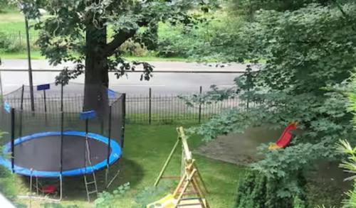 a playground with a tree and a trampoline at Loft bei Hamburg bis 12 Personen in Buchholz in der Nordheide