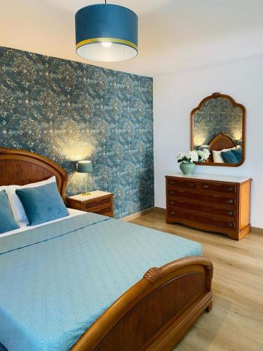 a bedroom with a large bed and a mirror at BEACH Arguineguin SEA VIEW 6 CHG FAMILY HOTEL in Arguineguín